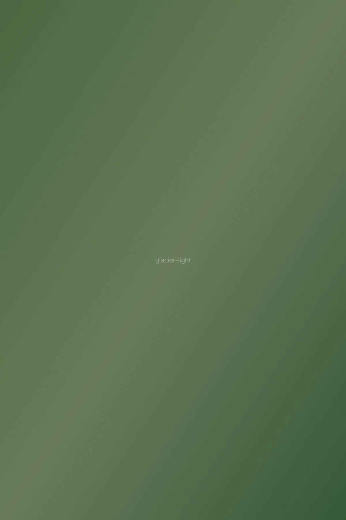 Glacier reflecting pale blue light in late afternoon