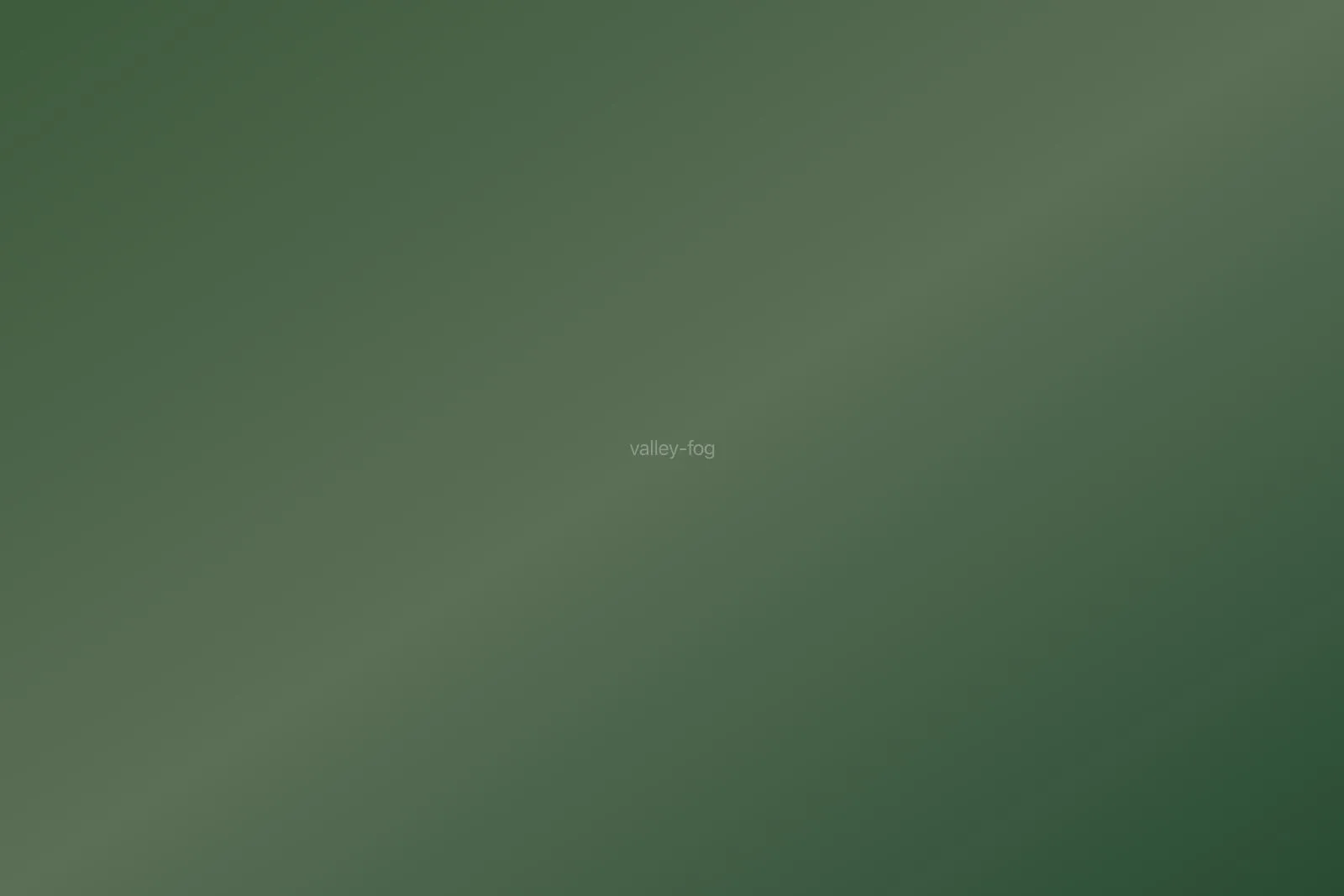 Fog filling a mountain valley at sunrise